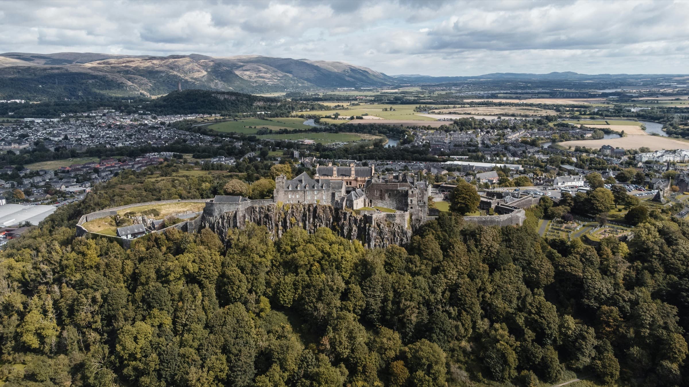 Aerial view of Stirling Castle on its rocky crag with the Ochil hills in the distance