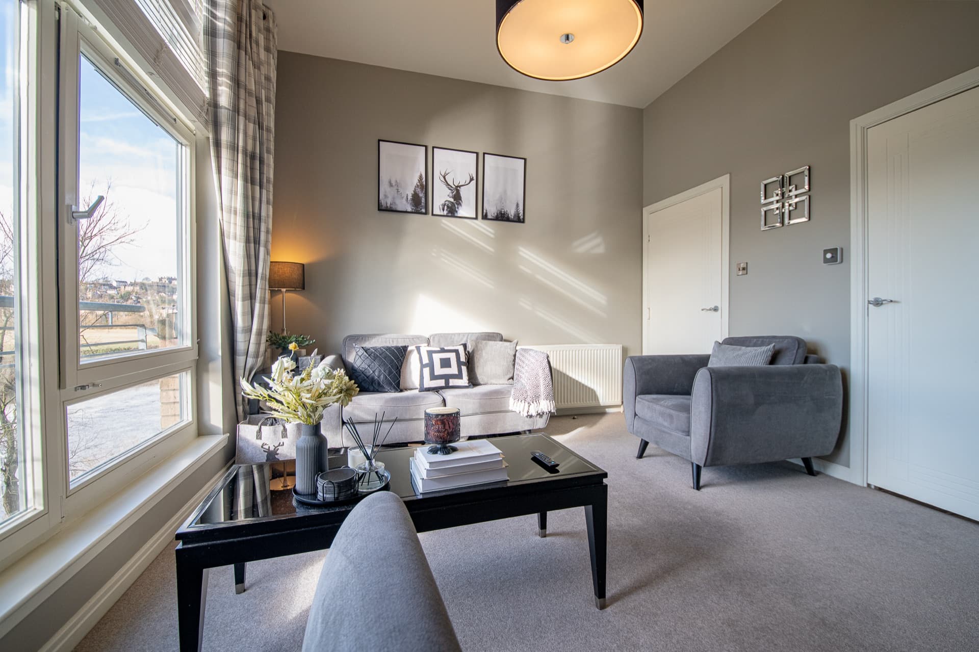 Living room with river-facing windows and natural light